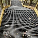 Disclaimer: Please note that the specific products showcased in these images are not manufactured or owned by Direct Metals® but represent the potential applications of similar products we supply. Fiberglass floor grating steps with wire mesh handrail inserts at a national park, similar to products from Direct Metals®.